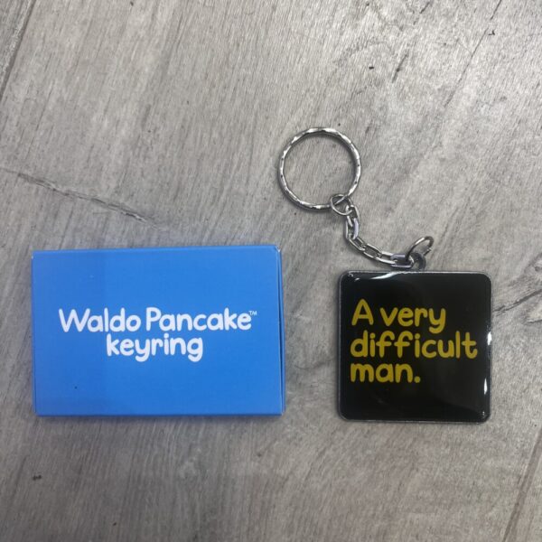 'A Very Difficult Man' Metal Keyring by Waldo Pancake